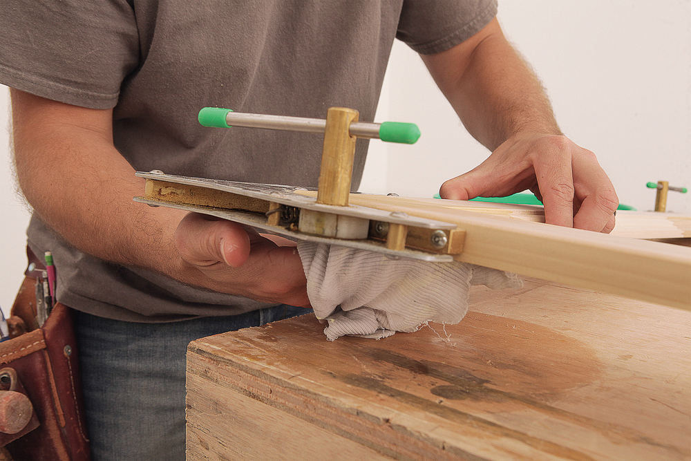 A damp rag removing squeeze-out from the back of the joint and from the table