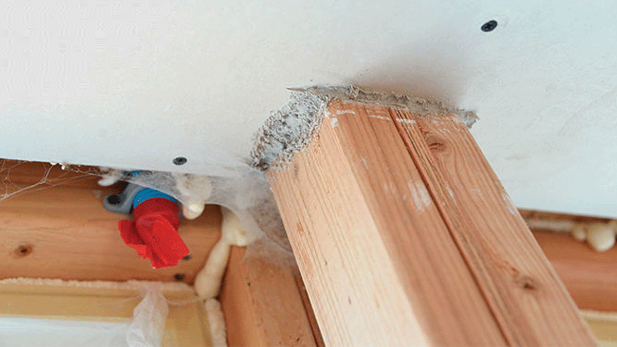 Builds up bit by bit. Aided by the pressure from a blower door, the sealant slowly accumulates at gaps and cracks as it travels with the escaping air. You can see the buildup around electrical boxes and any gaps in the drywall.