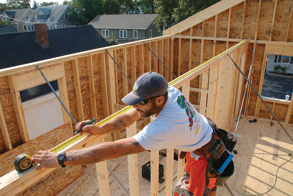 Once all of the exterior walls are braced, move to bearing walls and any walls with point loads (such as those with a perpendicular beam). Then straighten and brace any beams. It’s important to wait until all walls are braced before marking joist layouts