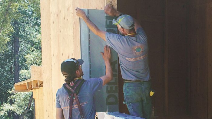People working on the exterior of the home 