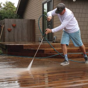 Finish with a light rinse. After scrubbing, rinse the deck surface with a pressure washer equipped with a 40° tip. The wide nozzle won’t damage wood fibers like more aggressive tips. Start at the house and work toward the edge, pushing the dirt as you move.