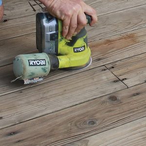 Sand rough spots. Sanding the whole deck is unnecessary, but split or checked boards should be sanded to prevent painful splinters. Ensure fasteners are driven below the deck surface before sanding.