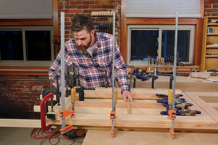 Bringing the layers together fully is of utmost importance to the strength of the finished door, so don’t be shy about using any and all clamps you can lay your hands on.