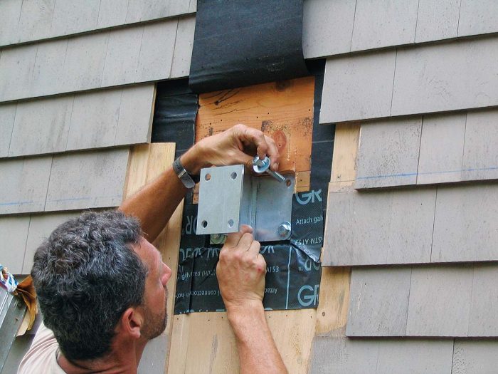 Ledger-fastening methods including the Maine Deck bracket (shown), the Metwood MTW Deck Bracket, and the BR Brick Bracket can often solve specific ledger-installation difficulties resulting from thick claddings.