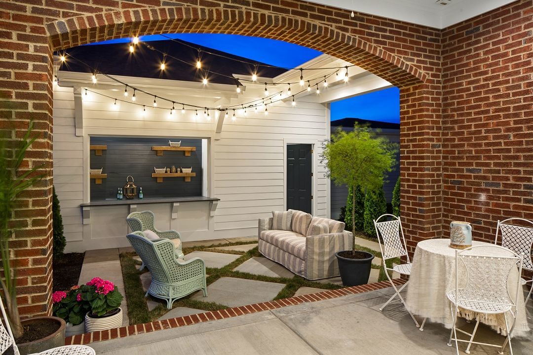 3 Car Garage Arched Garage Opening Courtyard Style Home Brick And Stone