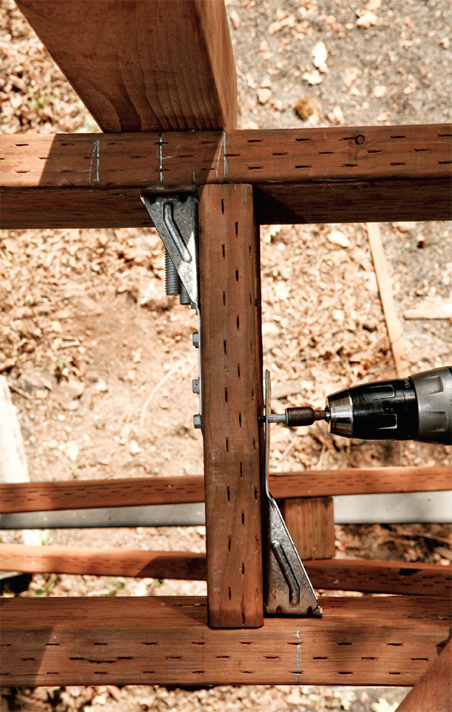 The tensioner hardware transfers any load applied to the post to the joist and decking assembly.