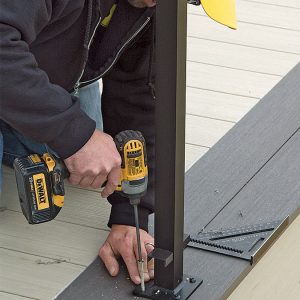 person installing the post on the deck