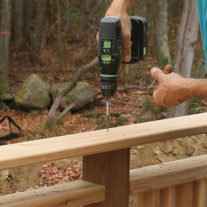 Make the cap rail from straight decking boards. Because the tops of the posts are pitched slightly, the cap rail slopes outward to shed water. Screw the cap rail down with stainless-steel trim-head screws.