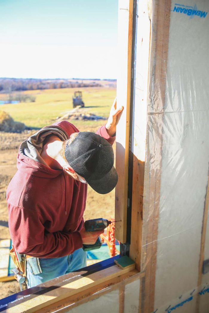 create a gap for insulation, nail small scraps of sheathing to the top of the back dam, giving the window a place to sit.