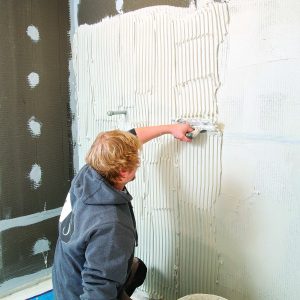tile walls first to avoid damaging floors