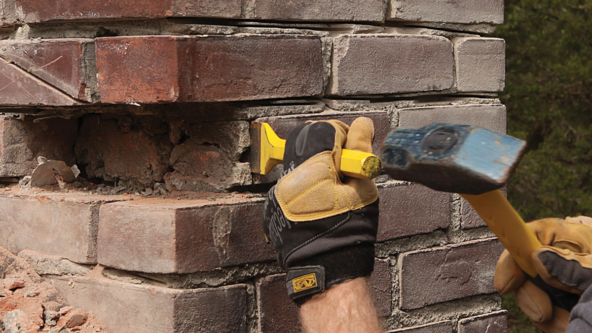 Clean the old. After removing a brick, the remaining mortar typically comes out easily. A steeply-angled chisel and a few light taps are often enough to break its bond with the brick.