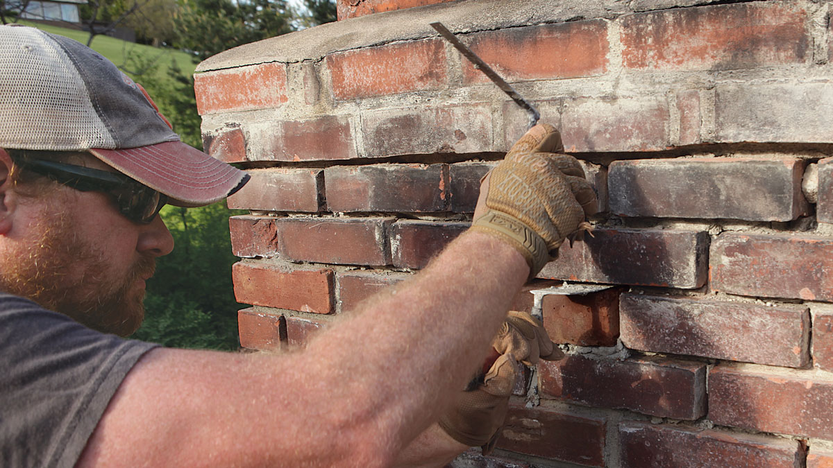 Level it. Slide a margin trowel into the open top joint and use another trowel to tap down on the brick and level it both side to side and front to back