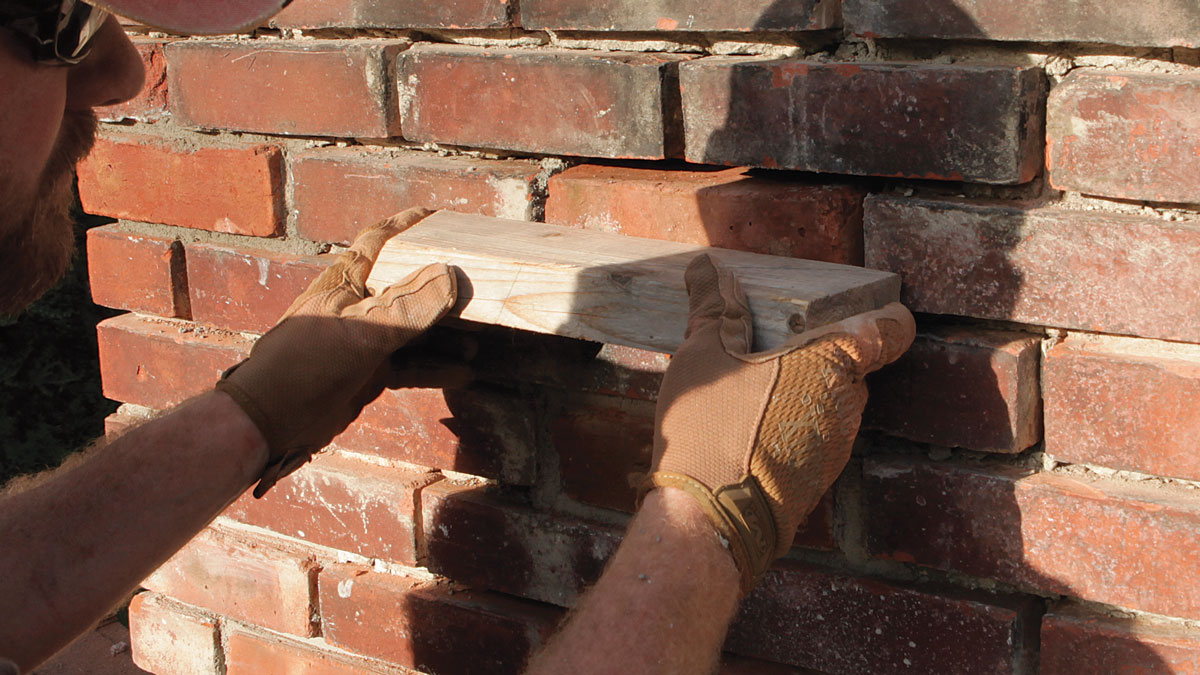 Plane it. Use a short length of 2x4 to help push the brick flush with its neighbors on all sides and check for general flatness.