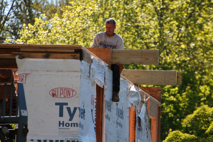 Re-framing the floor also allowed the team to lose a step down into the attic from a newer part of the house, and to add a cantilevered balcony on one of the gable ends.