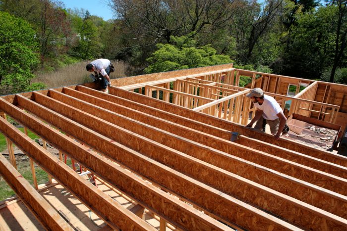 To support the heavier load, new TJI joists were installed. TJIs are stronger and lighter than dimensional lumber, but the wide 30-ft. span still requires them to bear on a center wall below.