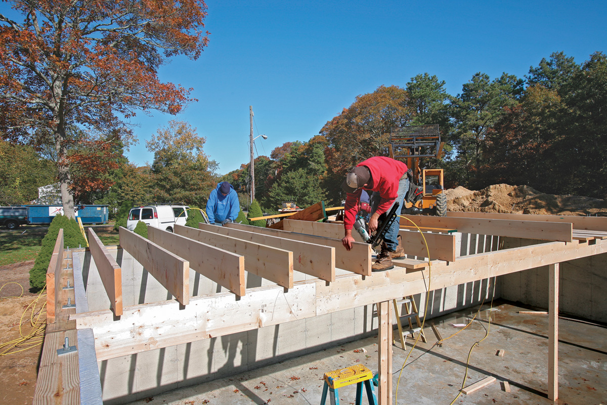When the beam has been stabilized, roll the remaining joists on edge and nail them to the layout.