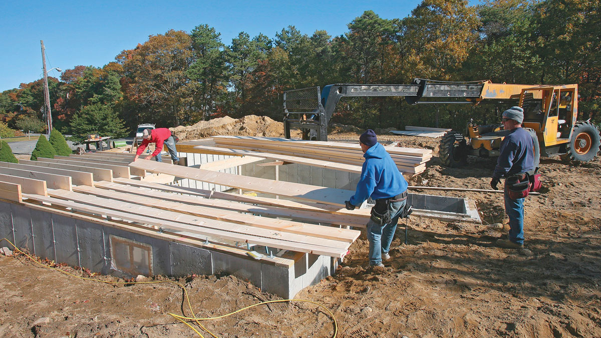 With the beam held in place by the front joists, the back joists can easily be loaded and installed.