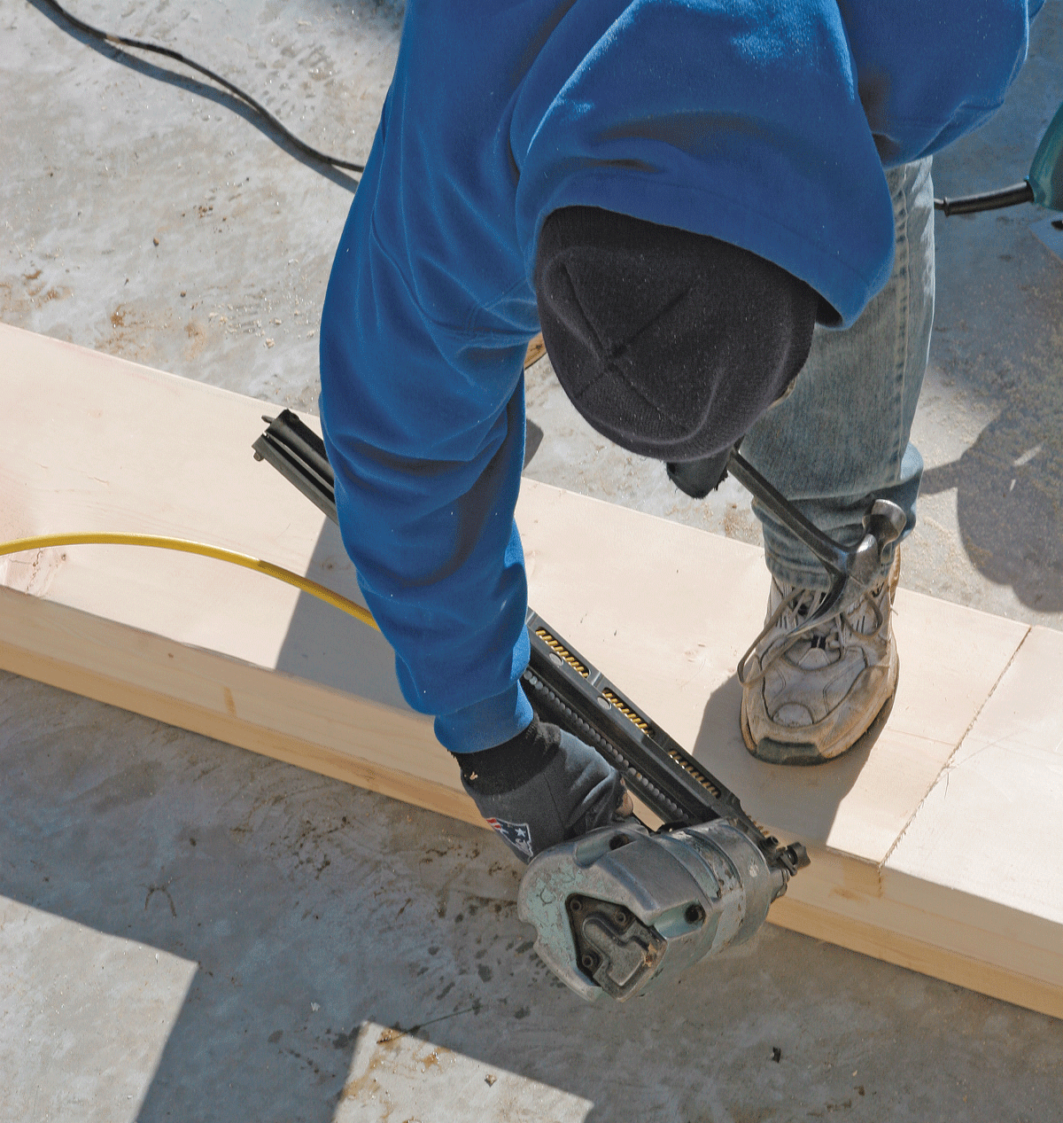 To align boards edge to edge, drive a toenail into the edge of the overhanging board, then pound the nail with a hammer until the board edges line up.