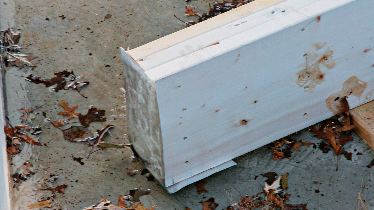 Aluminum flashing nailed to the ends of the support beam provides added protection against rot.