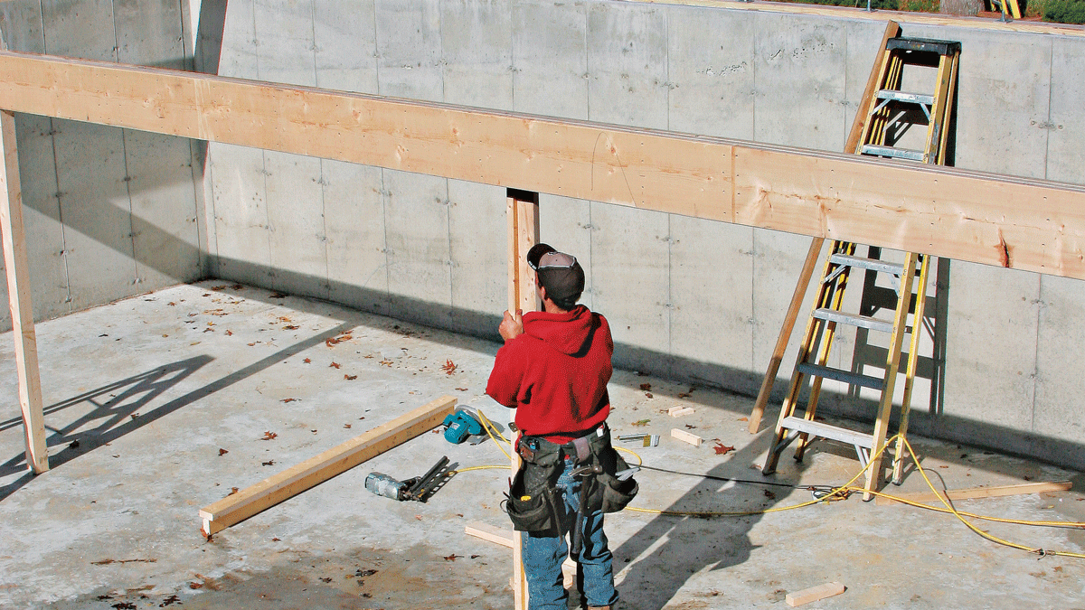 Temporary posts nailed in a T-shape can be tacked to the underside of the beam for support.