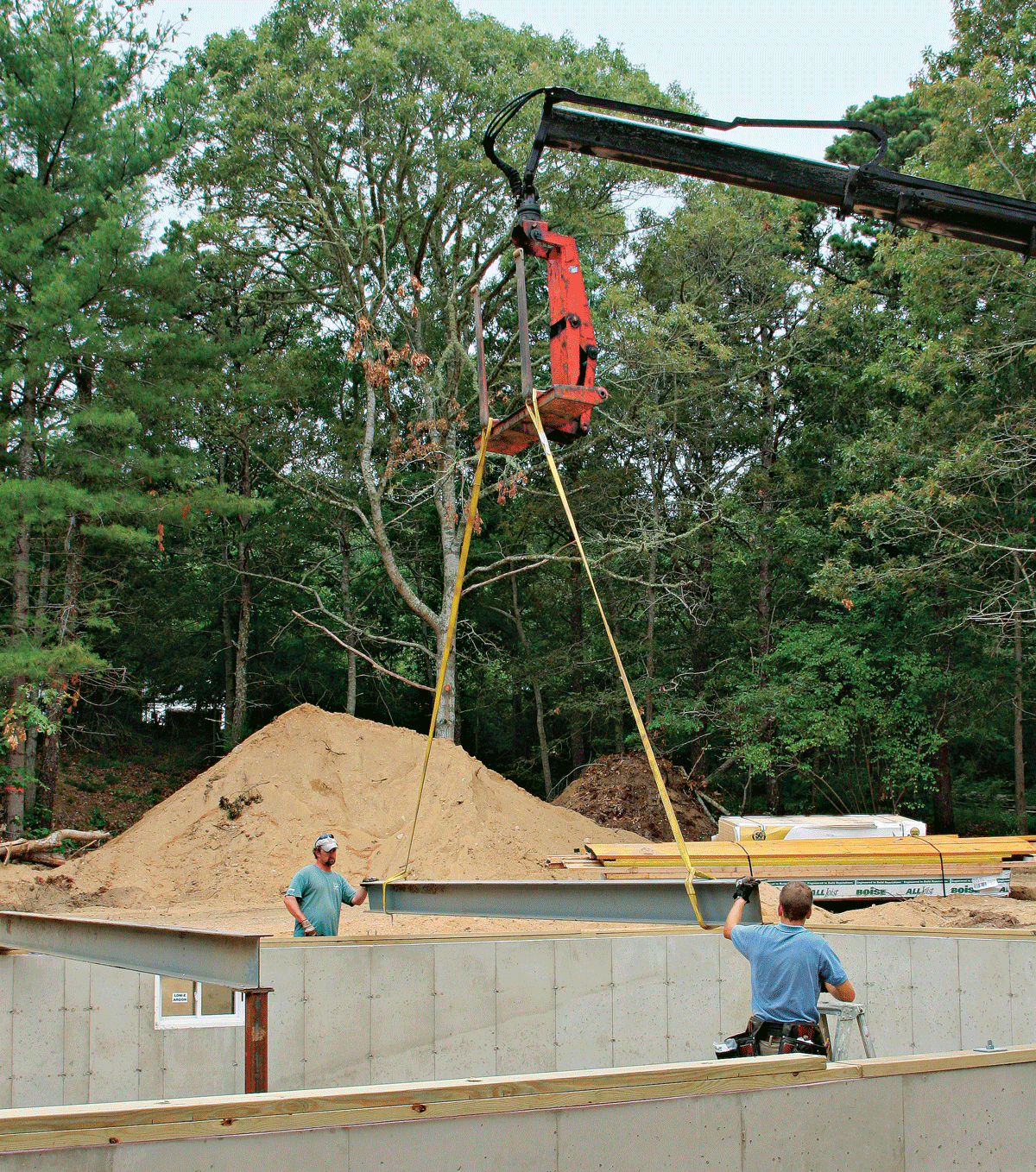 A steel beam can span greater distances than wood, but you’ll definitely need a crane to get it into place.