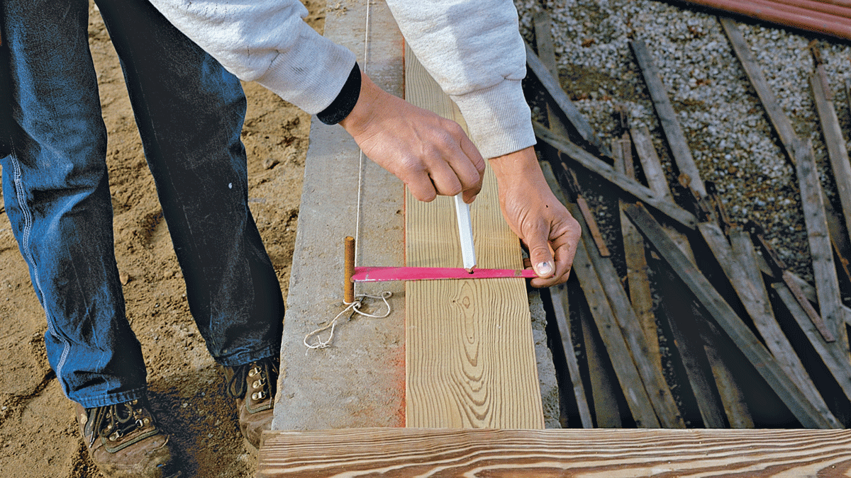 A homemade jig registers against the bolt and includes a hole for marking the bolt-hole location. This jig works best with 10-in. foundations or wider.