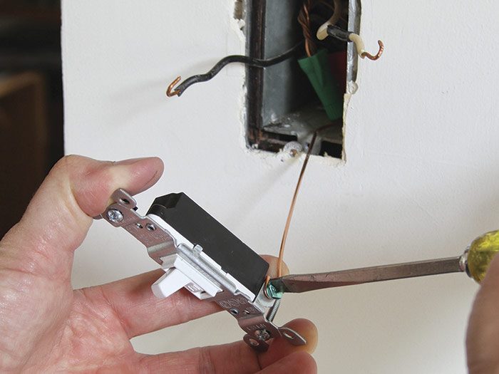 6 Attach the grounding wire to the new switch’s ground screw.