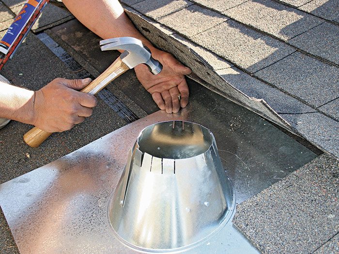 7  Nail only the top corners of the vent—shingles cover these nails.