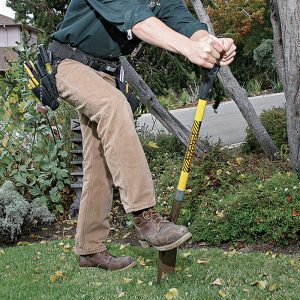 A  Use a square-nosed shovel to create shallow slots so you can tuck lo-vo cable into the ground.