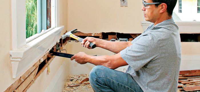 Use a hammer and a flat bar to pry the lath free from the studs.