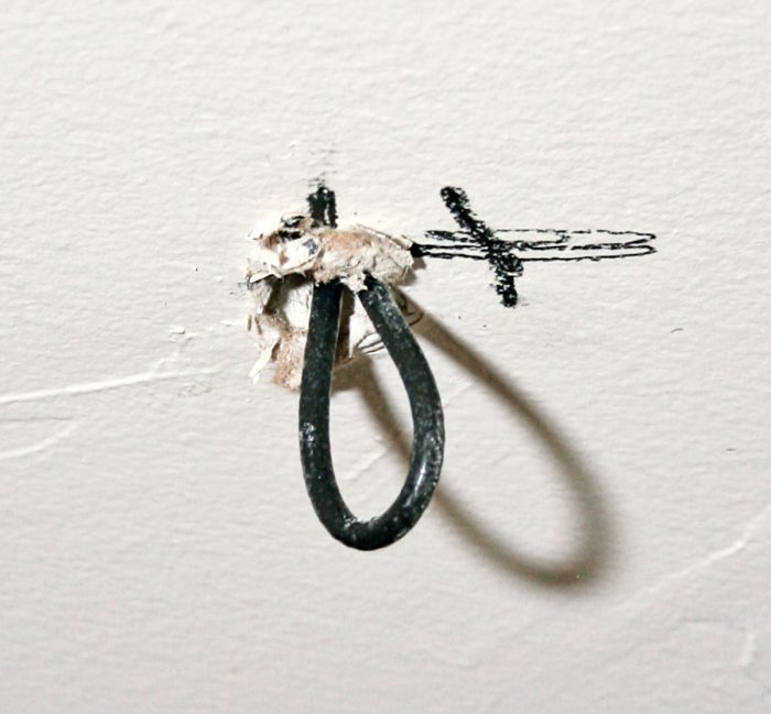 If you’re working alone, jam a long, looped wire into the exploratory hole, then go into the attic to look for it.