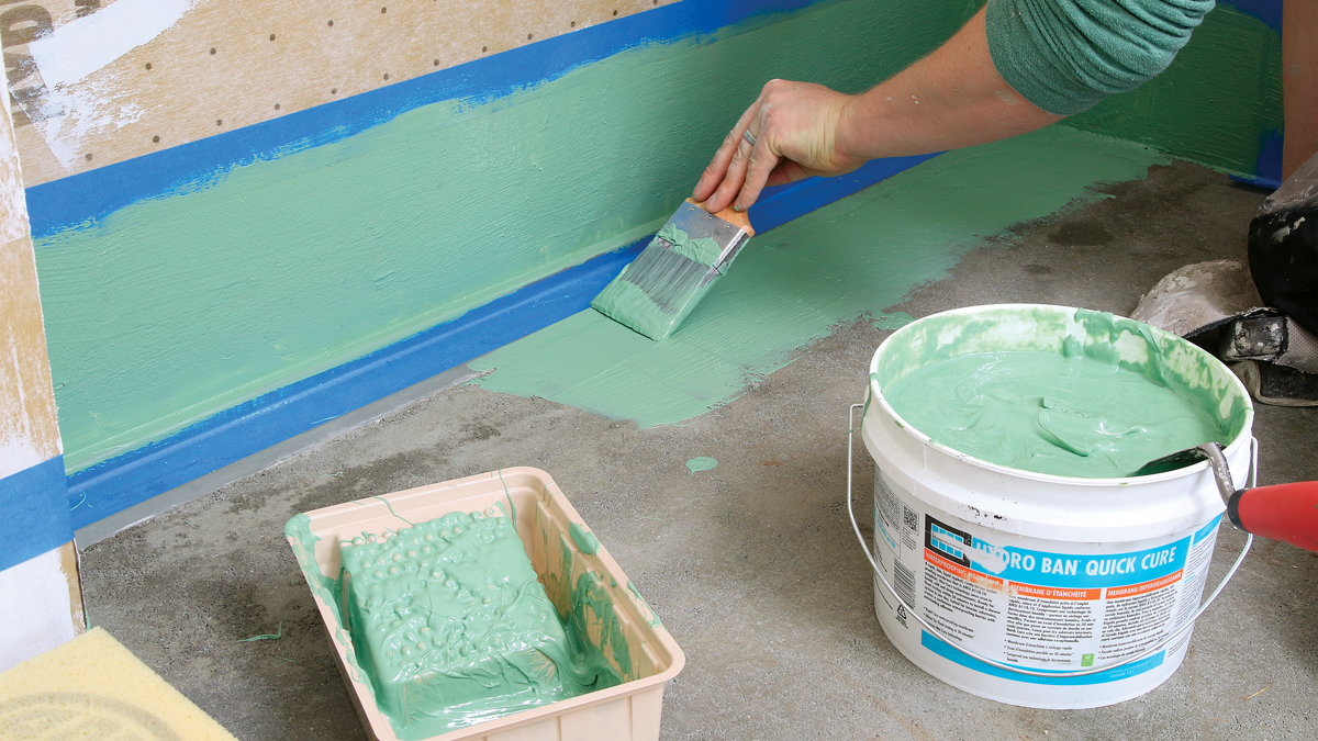 Liquid-applied membrane is a versatile tool. After finishing the mud-bed pan, I waterproof the drain area with two coats of a quick-curing liquid membrane from Laticrete, building a seal 6 in. up and out in all directions. 