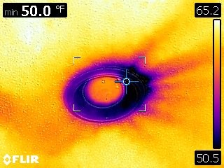 Leaking recessed can during blower door test.
