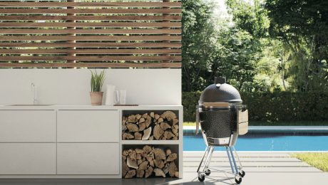 White outdoor countertop next to bbq by a pool