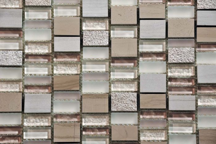 Many netted mosaics combine different types of tile for a unique installation. This one shows frosted and clear glass along with natural stone, textured, and smooth tiles.