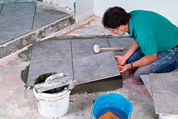 Large floor tiles require large-format thinset to support the weight and aid in leveling the tile.