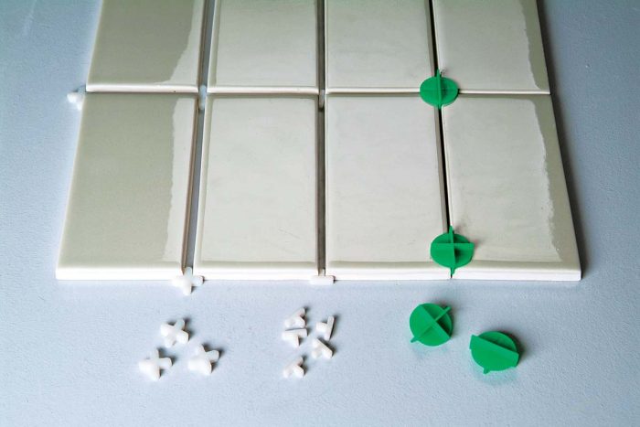 Tile spacers hold the tile at a fixed distance, allowing you to create regular even grout lines.