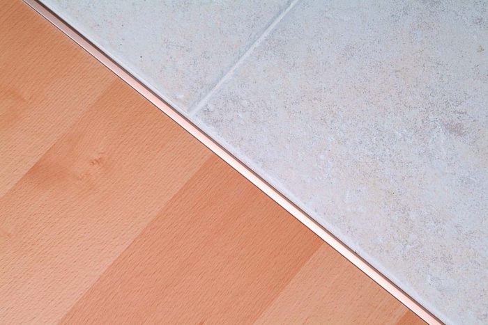 A smooth transition was made between the tile and a laminate wood floor.