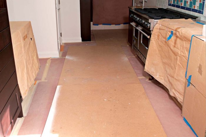 Rosin paper covered by Masonite provides thorough protection for any finished floor.