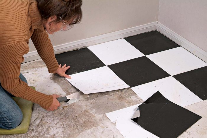 Vinyl squares lift up easily with a margin trowel or floor scraper.