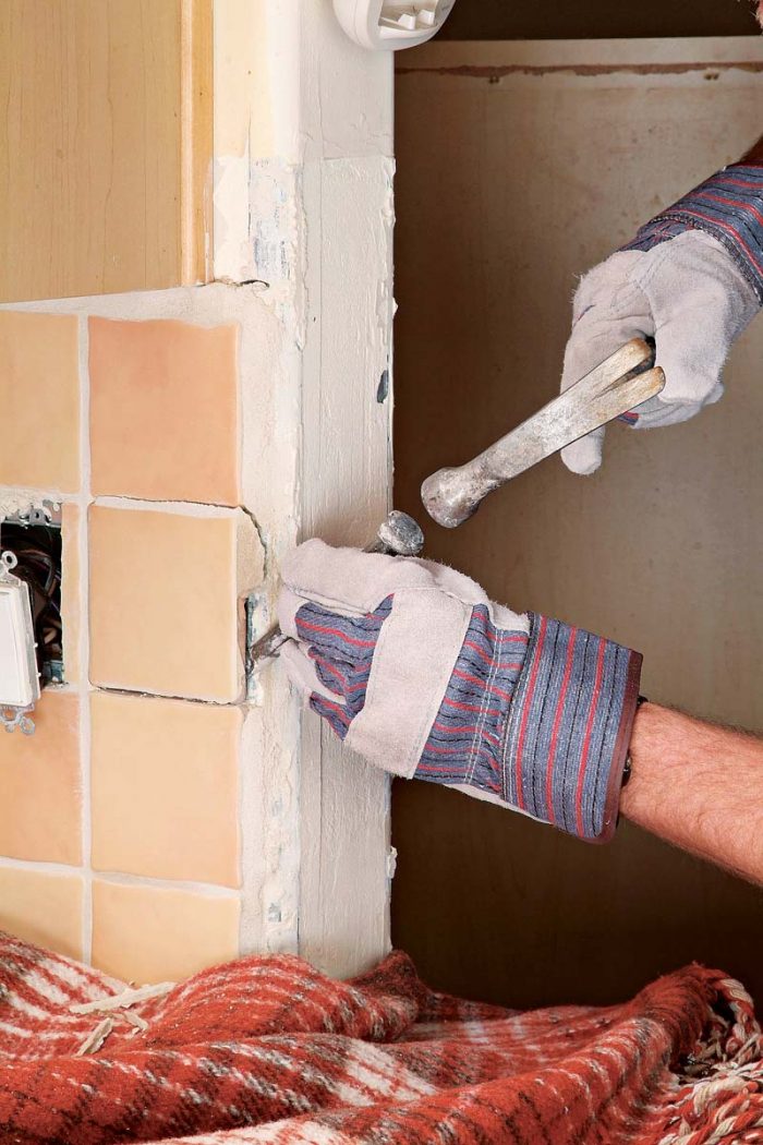 Carefully use a hammer and chisel to remove edge tiles.