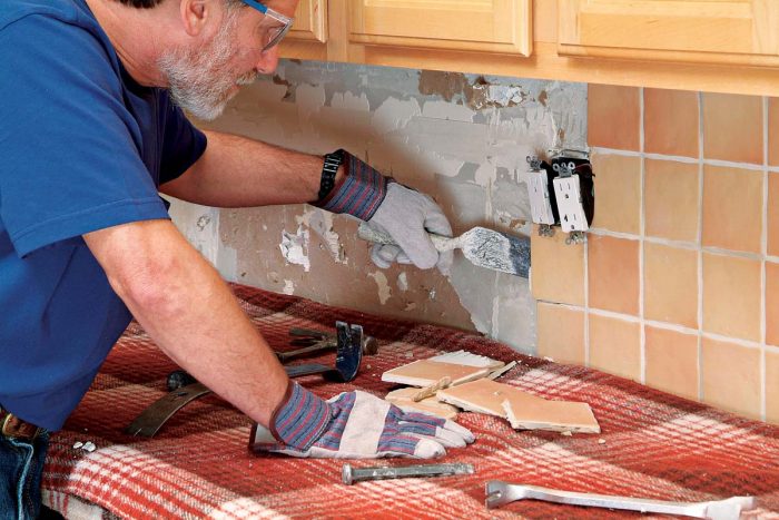 A margin trowel may also be used to lift or pull tiles away from the wall.
