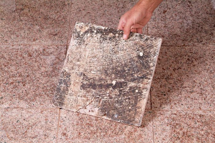 Tile installed on a concrete floor with old mastic left on it won’t bond properly and, eventually, will come loose.