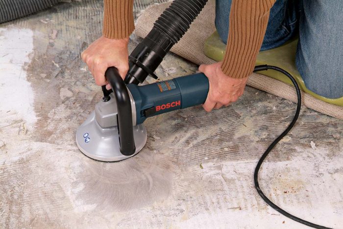 You can reduce small bumps in a concrete floor with a concrete grinder, connected to a shop vacuum to reduce dust output.