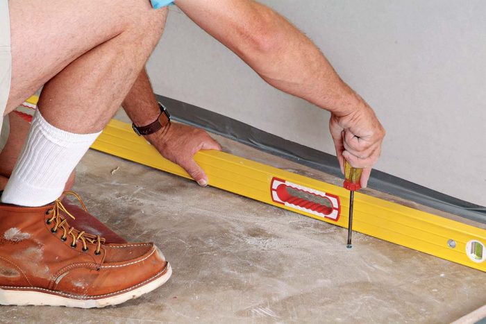 Set the screw head nearest the floor’s high point about 1/8 in. above the floor.