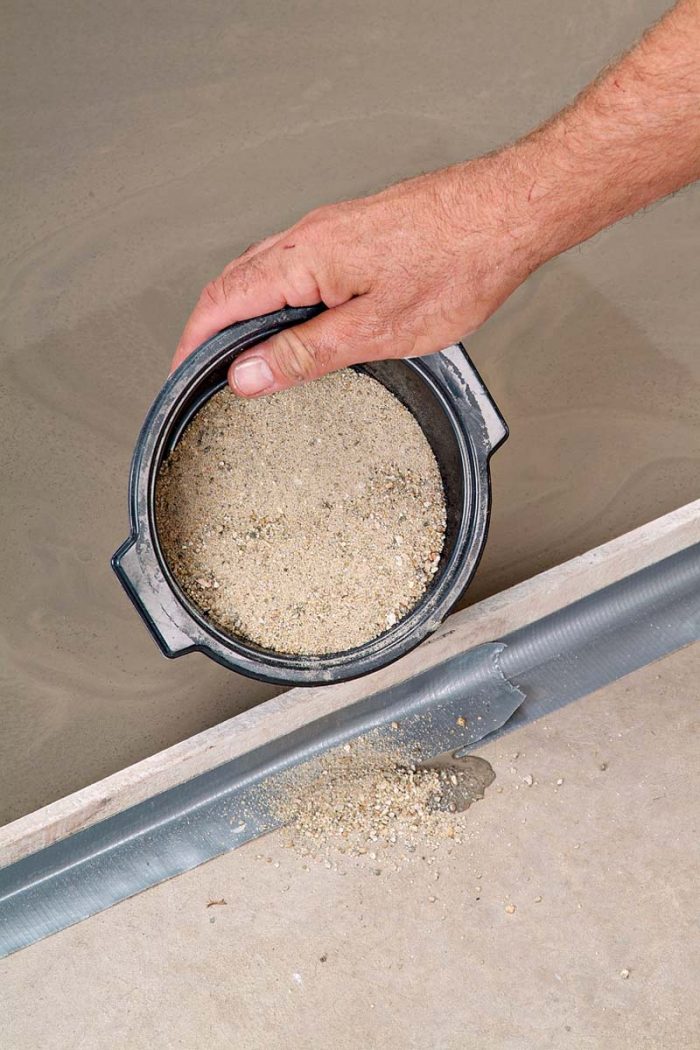 Shake out a small amount of sand to stop any leaks from the self-leveler.