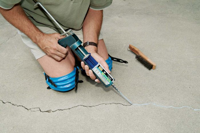 Use concrete epoxy to fill any crack over 1/8 in. wide before applying a two-part antifracture membrane.
