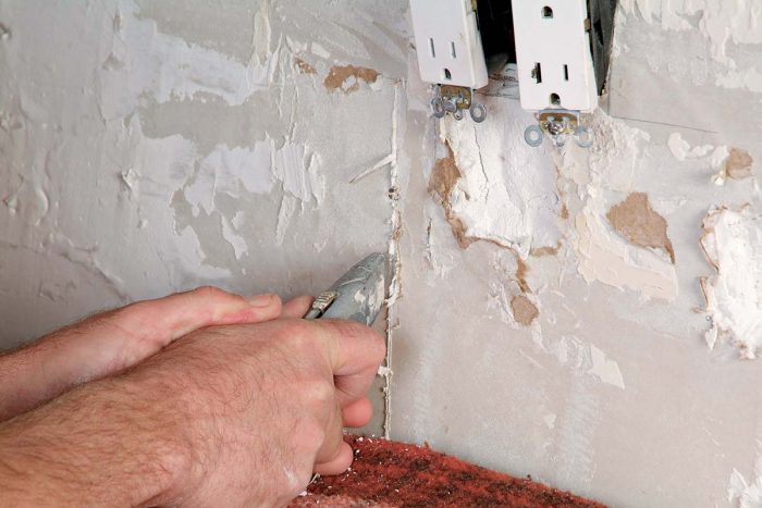 Cut out the damaged area of drywall with a razor knife.