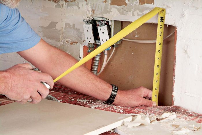 Measure the size of the opening for a new drywall patch.
