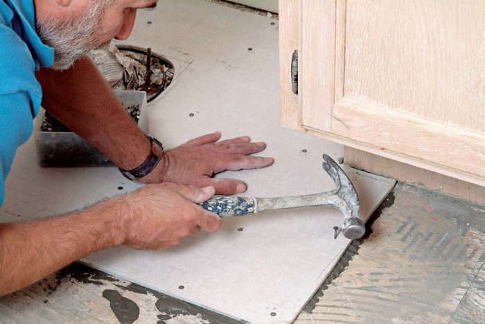 In cramped areas, like under cabinet toekicks, use the side of the hammer head to bang nails into place.
